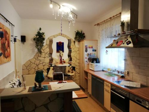 a kitchen with a counter and a stone wall at Charly's Home in Villach