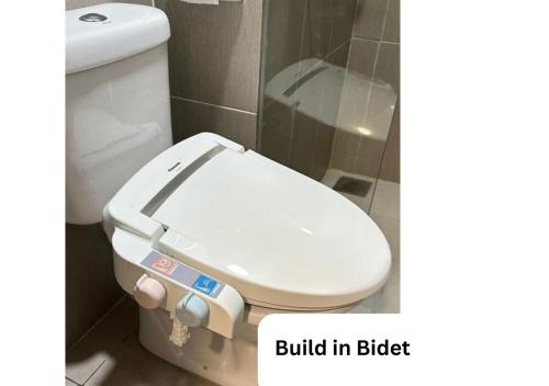 a bathroom with a toilet with a built in bidet at Yu Hotel Chinatown in Kuala Lumpur