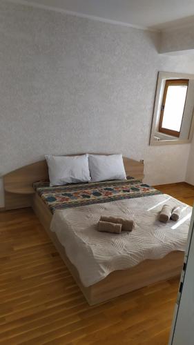 a bed with two pillows on it in a bedroom at Villa Koteski - Spacious Apt, Near Lake & Parking in Ohrid