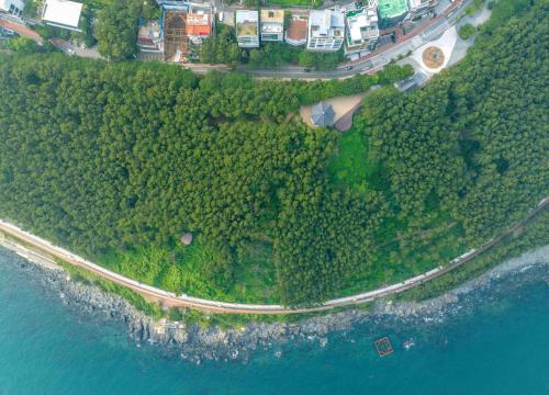 an aerial view of a road on an island next to the water at 500m2 Busan Ocean view private Let house in Busan