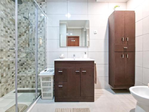 a bathroom with a sink and a shower at Apartment Praia Rocha Vista Mar Brownie in Portimão