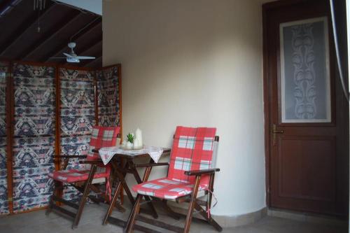 a table and chairs in a room with a door at Studio in Fourka in Fourka
