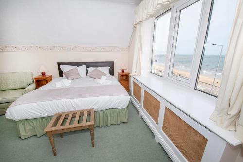 a bedroom with a bed and a window with the ocean at The Seacourt in Bridlington