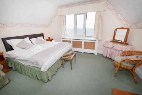 a bedroom with a large bed and a window at The Seacourt in Bridlington
