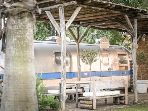a train station with a table and a train at PARADISE RANCH in Borgo Sabotino
