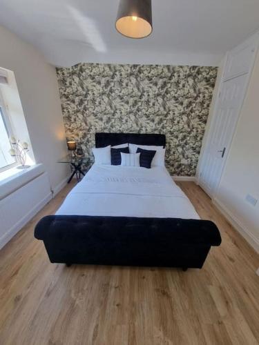 um quarto com uma cama grande num quarto em Somers Lodge em Leicester