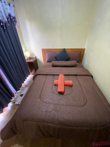 a bed with a stuffed animal on top of it at D'Yoga Bamboo House in Kintamani