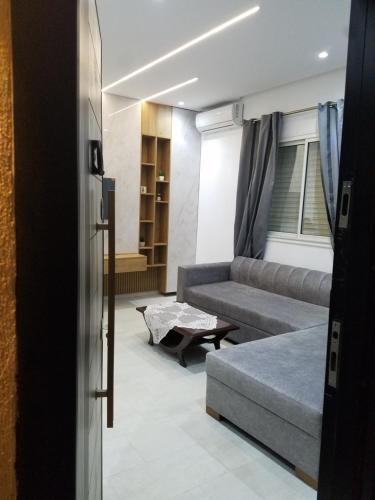 a living room with a couch and a table at Joli Villa à Sahloul in Sousse