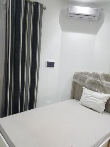 a small bedroom with a bed with a radiator at Joli Villa à Sahloul in Sousse