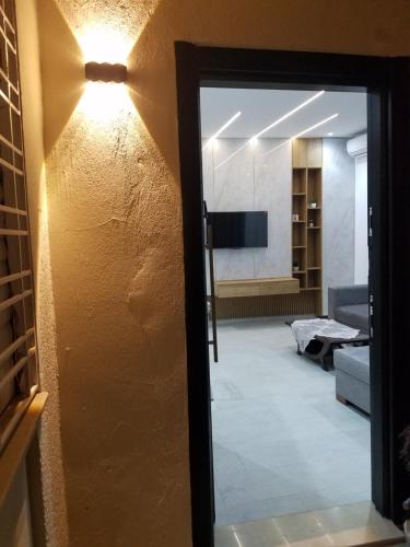 a door leading into a living room with a light at Joli Villa à Sahloul in Sousse