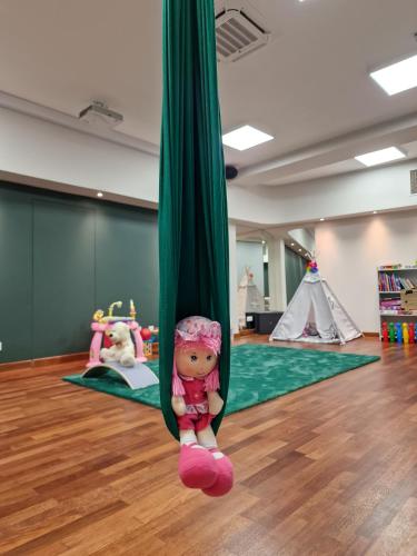 a doll is hanging from a green pole in a room at Hotel ARA - Dancing Club Restauracja ARA in Jastrzębia Góra