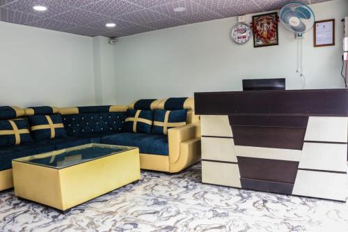 a living room with a couch and a table at RK GUEST HOUSE in Guwahati