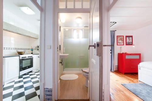 a small bathroom with a toilet and a kitchen at CHARMING 2 BEDROOM APARTMENT AVENIDA DA LIBERDADE in Lisbon