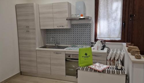 a kitchen with a sink and a stove top oven at Il Giardino Nascosto in Ascea