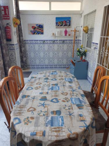 a table with a table cloth on it in a room at Coqueto alojamiento en Los Alcázares in Los Alcázares