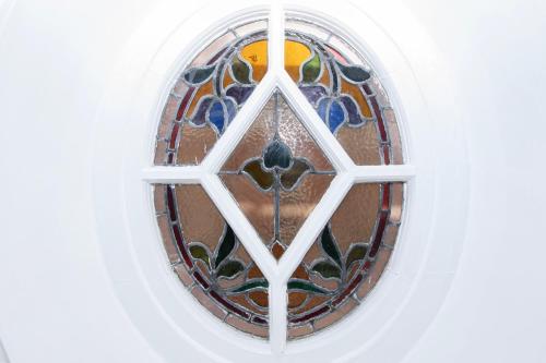 a stained glass window in a white wall at The Seacourt in Bridlington