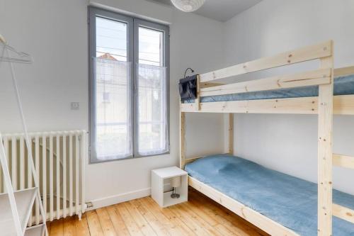 a bedroom with two bunk beds and a window at Maison Jules - 12 min Disneyland - 10 P in Esbly