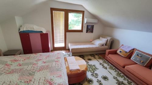 a living room with a bed and a couch at Curovac Nature in Ilidža