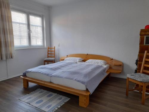 a bedroom with a wooden bed in a room with a window at Kleine Auszeit in Bad Fallingbostel