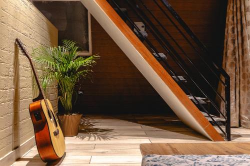 a surfboard sitting on the floor next to a stairs at The Soul Stroll Cottages Retreat in Mukteswar