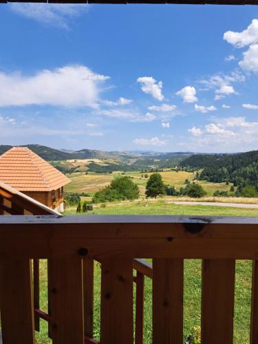 a view from the deck of a cabin with a view of the mountains at Etno domacinstvo Uvacki konaci in Nova Varoš