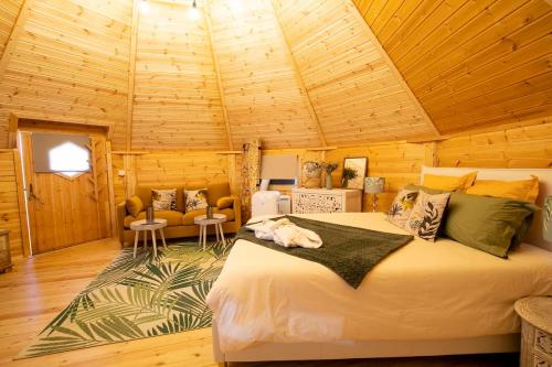 a bedroom with a large bed in a wooden room at Ô refuge di’vin in Bannay