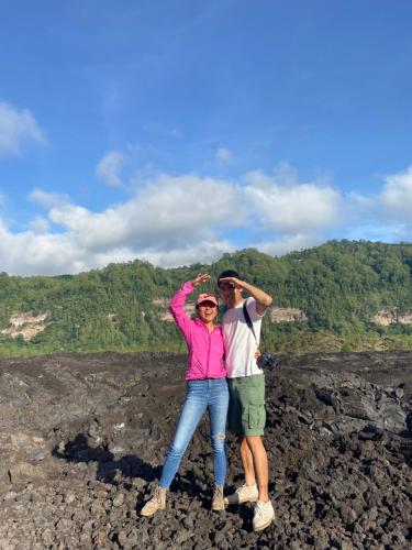 a man and a woman standing on top of a mountain at D'Yoga Bamboo House in Kintamani