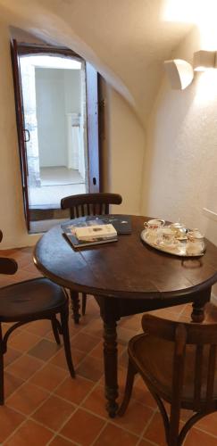 uma mesa de madeira com 2 cadeiras e um espelho em La Voûte Noble em Saint-Saturnin