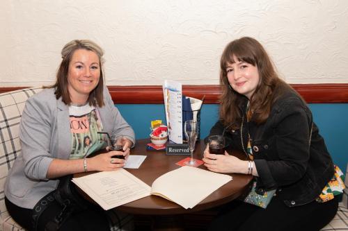 two women sitting at a table with wine glasses at The Seacourt in Bridlington