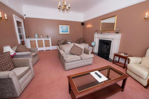 a living room filled with furniture and a fireplace at The Seacourt in Bridlington