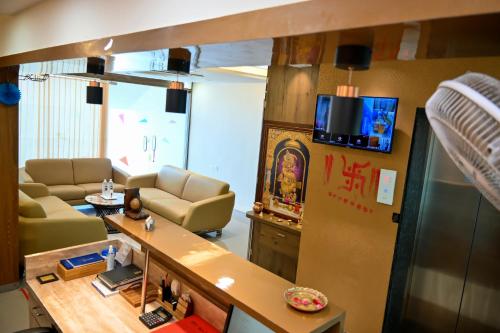 a living room with a couch and a table at Hotel Royal Ican Sindhu Bhavan Road in Ahmedabad