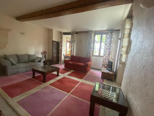 a living room with a couch and a table at Château de Bouesse en Berry in Bouesse