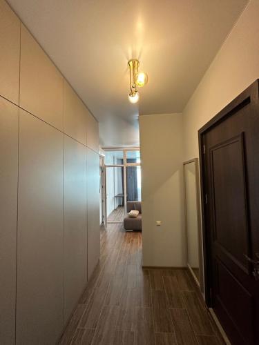 a hallway with a door and a couch in a room at Pirosmani Mini Hotel in Batumi