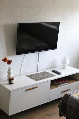 a white desk with a computer monitor on top of it at Blue Apartment in Bihać