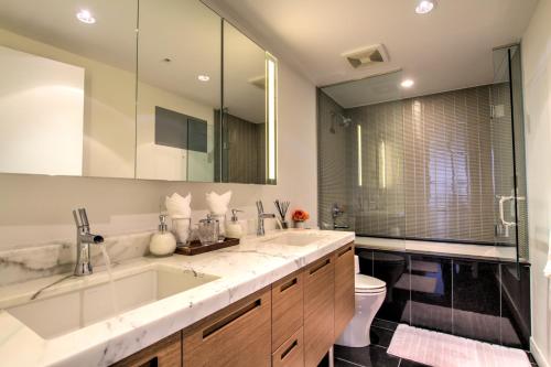 a bathroom with a large sink and a toilet at LuxeStay in Vancouver