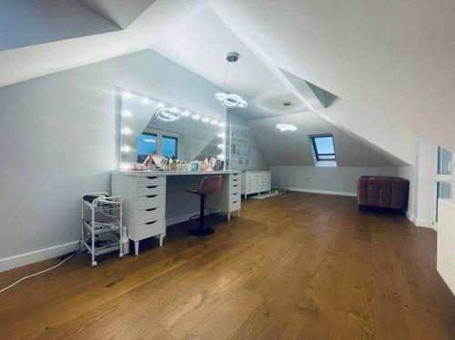 an attic room with a vanity and a mirror at Dream House SmartHome in Warsaw