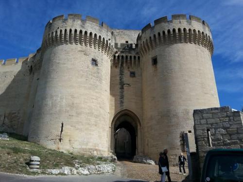 a large castle with people standing in front of it at Maison indépendante climatisée dans quartier calme in Villeneuve-lès-Avignon