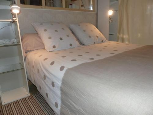 um quarto com uma cama grande e almofadas de bolinhas em Maison indépendante climatisée dans quartier calme em Villeneuve-lès-Avignon
