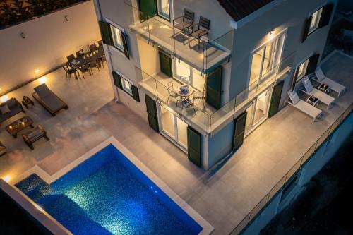 an aerial view of a house with a swimming pool at Epetium Beach Villa in Split