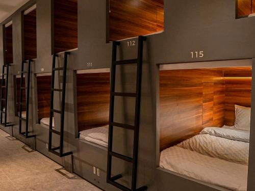 a row of bunk beds in a room at Ketje Luxury Capsule Lampung in Lampung