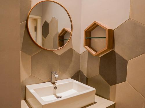 a bathroom with a sink and a mirror at Ketje Luxury Capsule Lampung in Lampung