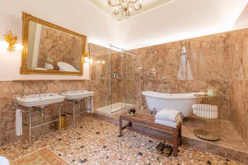 un ampio bagno con due lavandini, una vasca e una vasca di Corte Realdi - Palazzo Camozzini a Verona