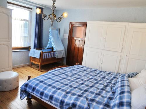 um quarto com uma cama, uma cadeira e uma janela em Cozy Holiday Home in Bastogne with Sauna em Bastogne