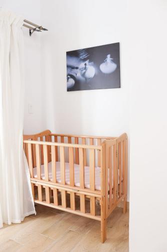 a crib in a room with a picture on the wall at Nabeel Homes - Seaview Rooftop - San Stefano in Alexandria
