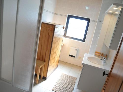 a small bathroom with a sink and a window at Stunning, wooden villa located in Durbuy in Durbuy