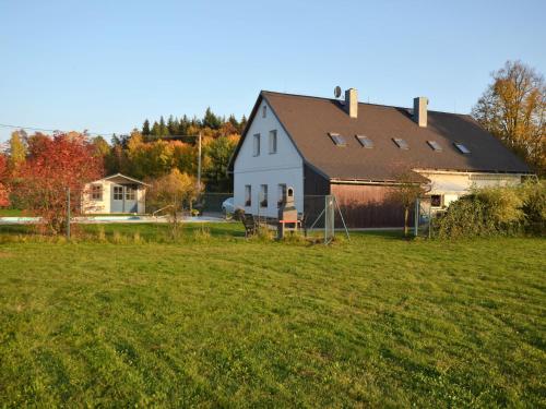 a large white house with a black roof on a field at Apartment in Nemojov near Forest and Pool in Horní Nemojov
