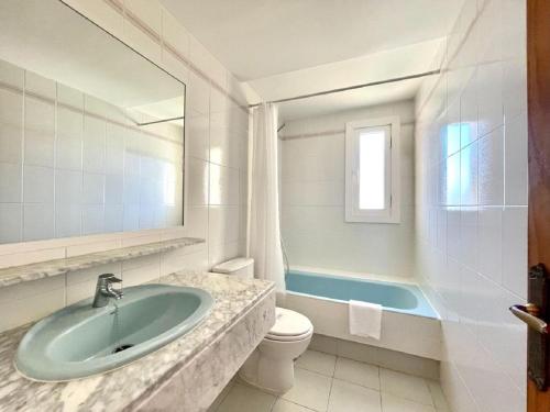 a bathroom with a sink and a toilet and a tub at Beachfront apartment in Roquetas de Mar with communal pool in Roquetas de Mar