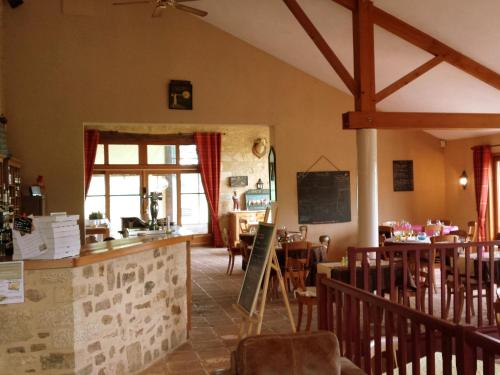 a restaurant with tables and chairs in a room at Villa in France with Private Pool in Vasles