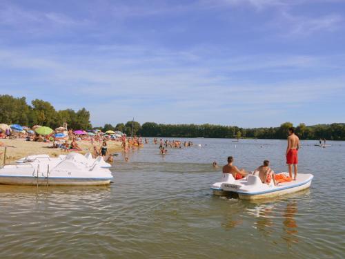 people on boats in the water at a beach at Villa in France with Private Pool in Vasles