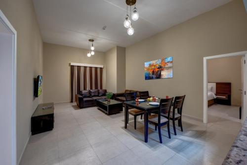 a living room with a table and a couch at City Stay Residences - Serviced Apartments DIP in Dubai